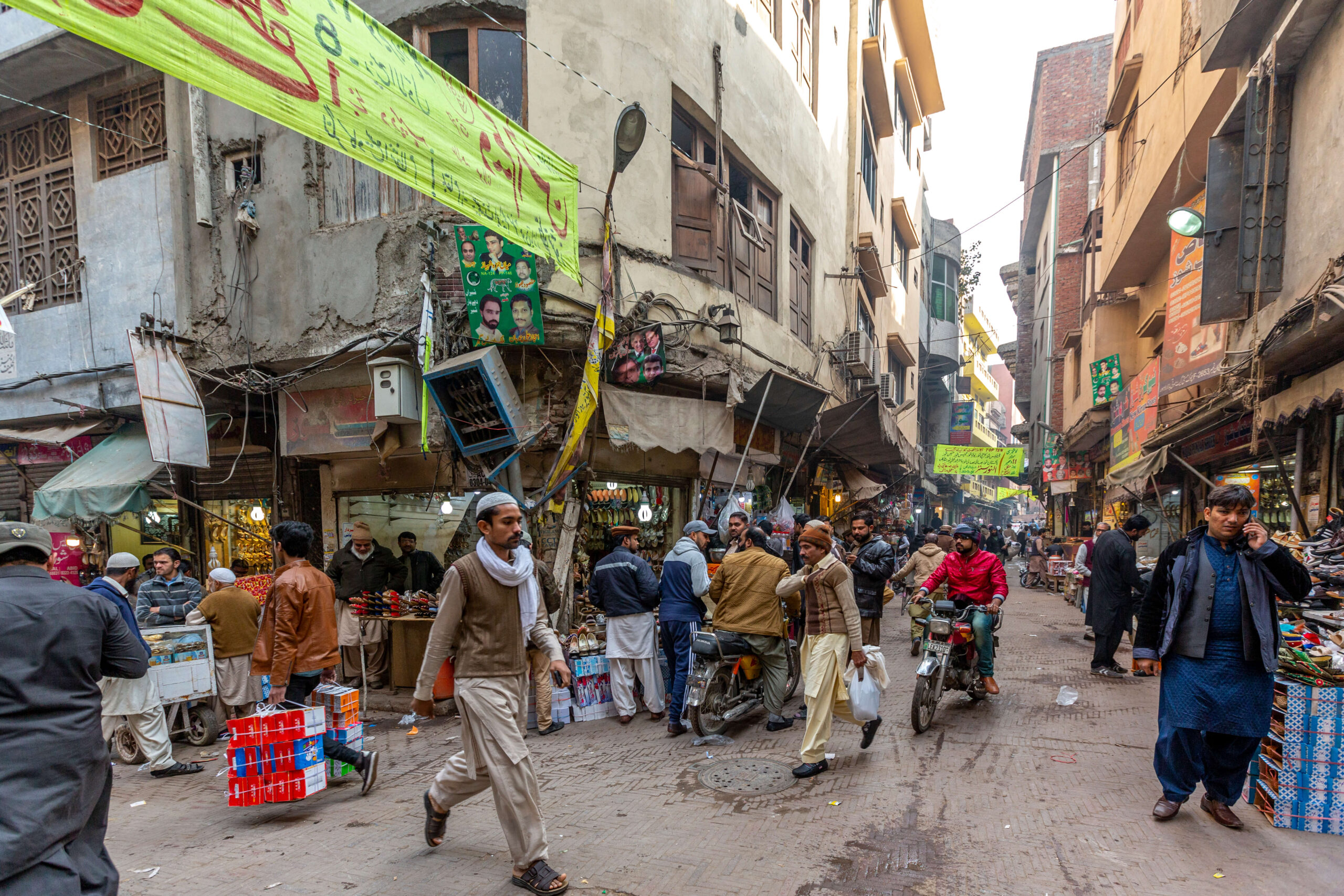 People on a busy street with shopping vendors